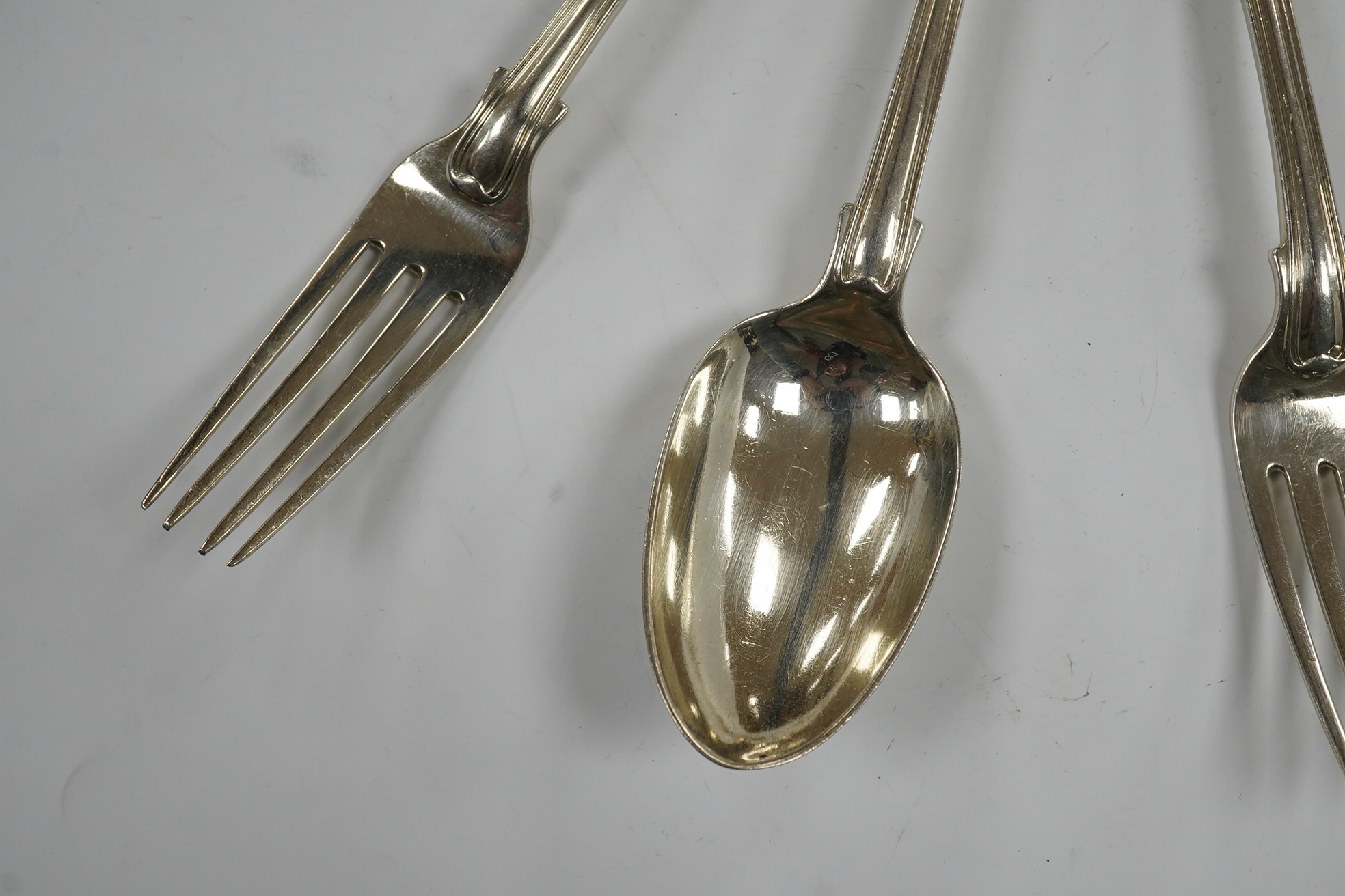 A set of six George IV silver fiddle, thread and shell pattern dessert forks and six matching spoons, William Chawner, London, 1827, 22.4oz. Condition - poor to fair